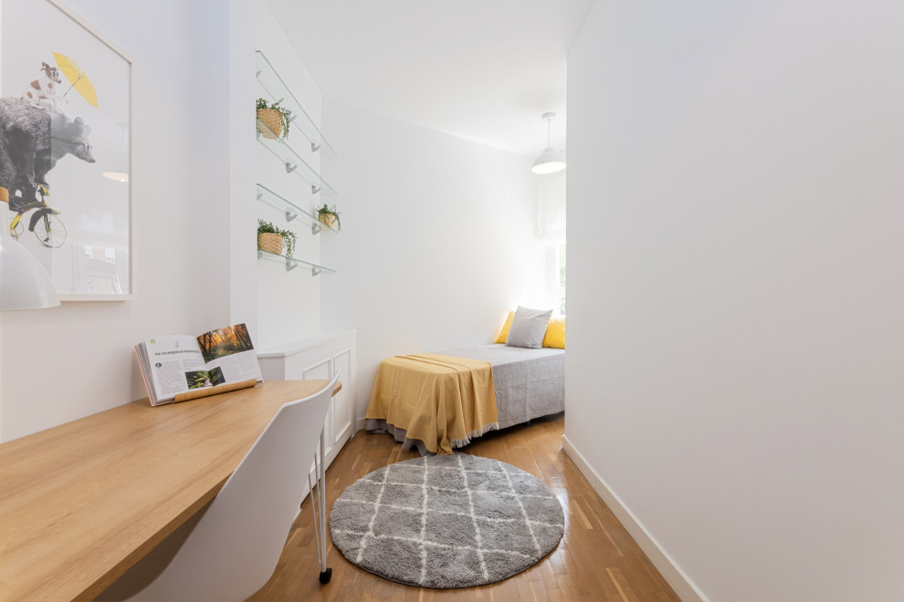 Contemporary gender-neutral kids' bedroom in Madrid with white walls and medium hardwood floors.