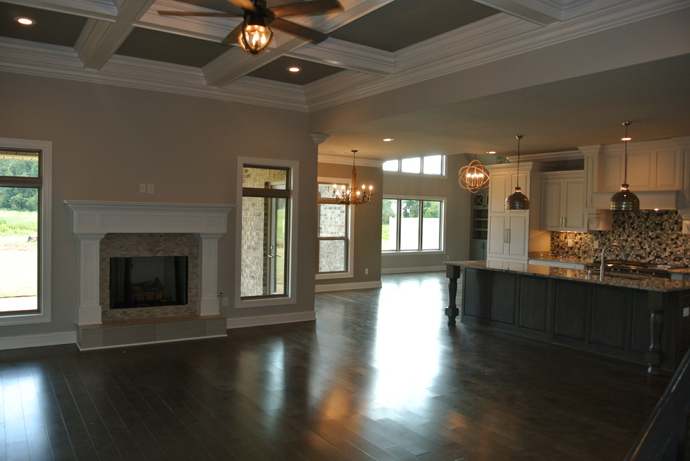 Inspiration for a rustic medium tone wood floor home design remodel with gray walls, a standard fireplace and a tile fireplace
