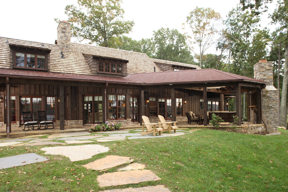 Inspiration for a large rustic brown two-story wood gable roof remodel in Other