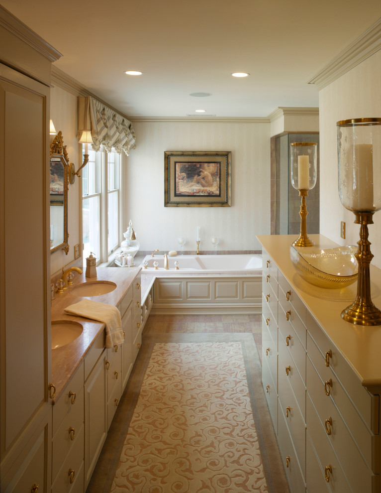Inspiration for a large traditional master bathroom in Providence with an integrated sink, flat-panel cabinets, white cabinets, solid surface benchtops, an alcove tub, a corner shower, beige tile, beige walls and light hardwood floors.