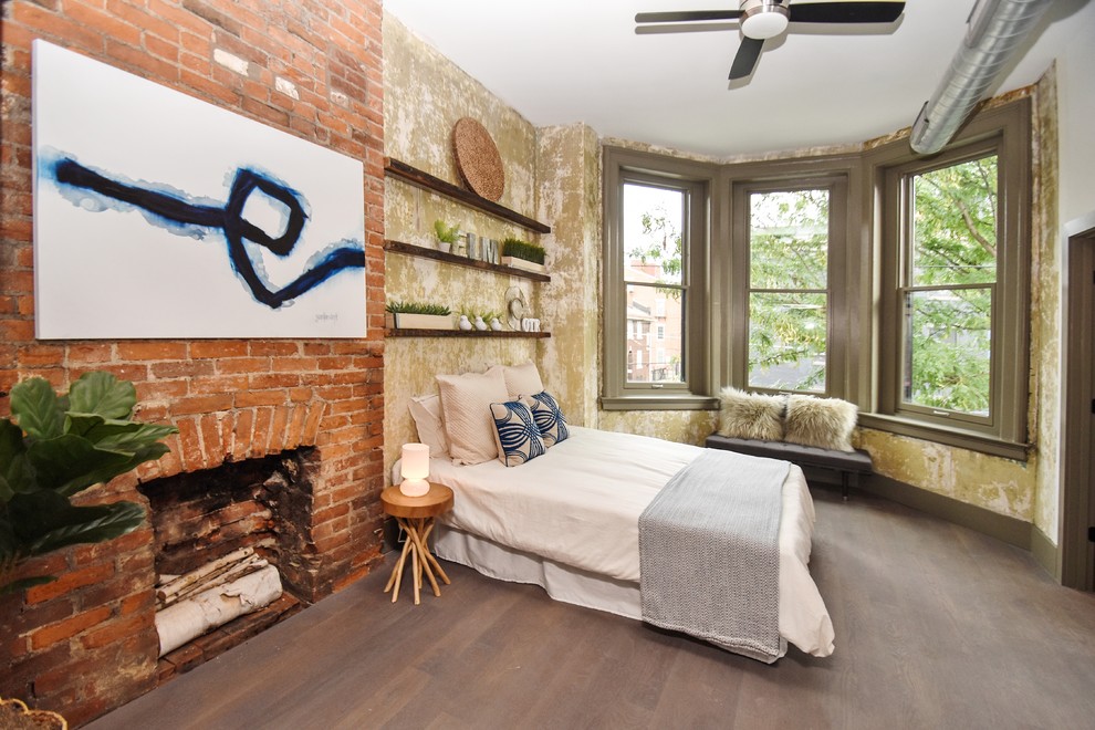 Industrial bedroom in Cincinnati with a standard fireplace and a brick fireplace surround.