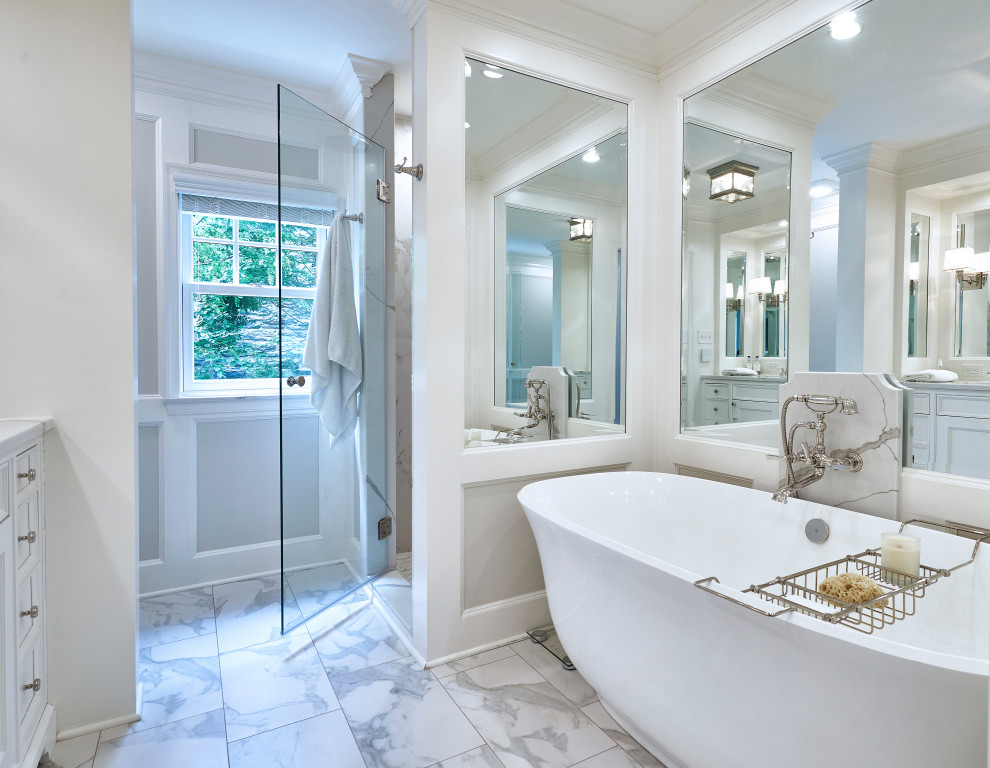 Photo of a traditional master bathroom in Philadelphia with shaker cabinets, white cabinets, a freestanding tub, a corner shower, gray tile, marble, grey walls, marble floors, a console sink, quartzite benchtops, grey floor, a hinged shower door, white benchtops, a double vanity, a built-in vanity and panelled walls.