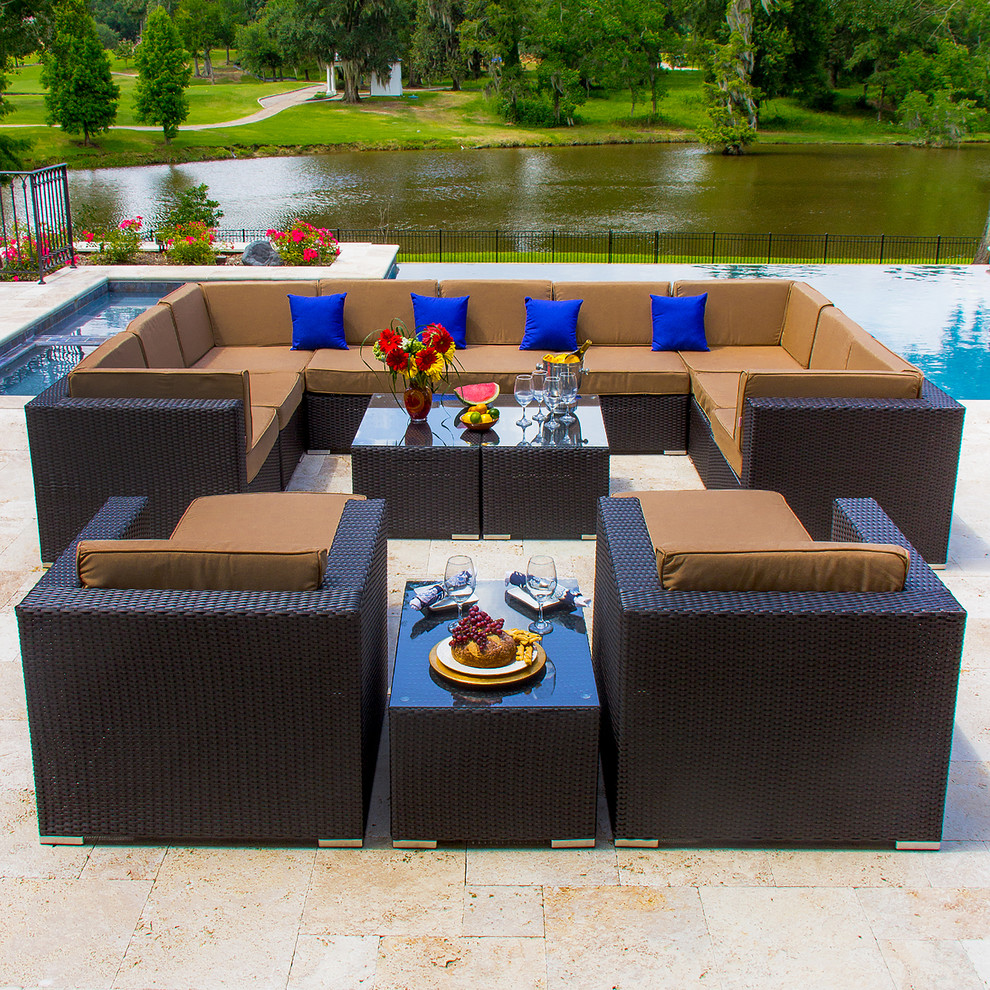 Photo of a large contemporary backyard patio in New Orleans with a water feature, tile and no cover.