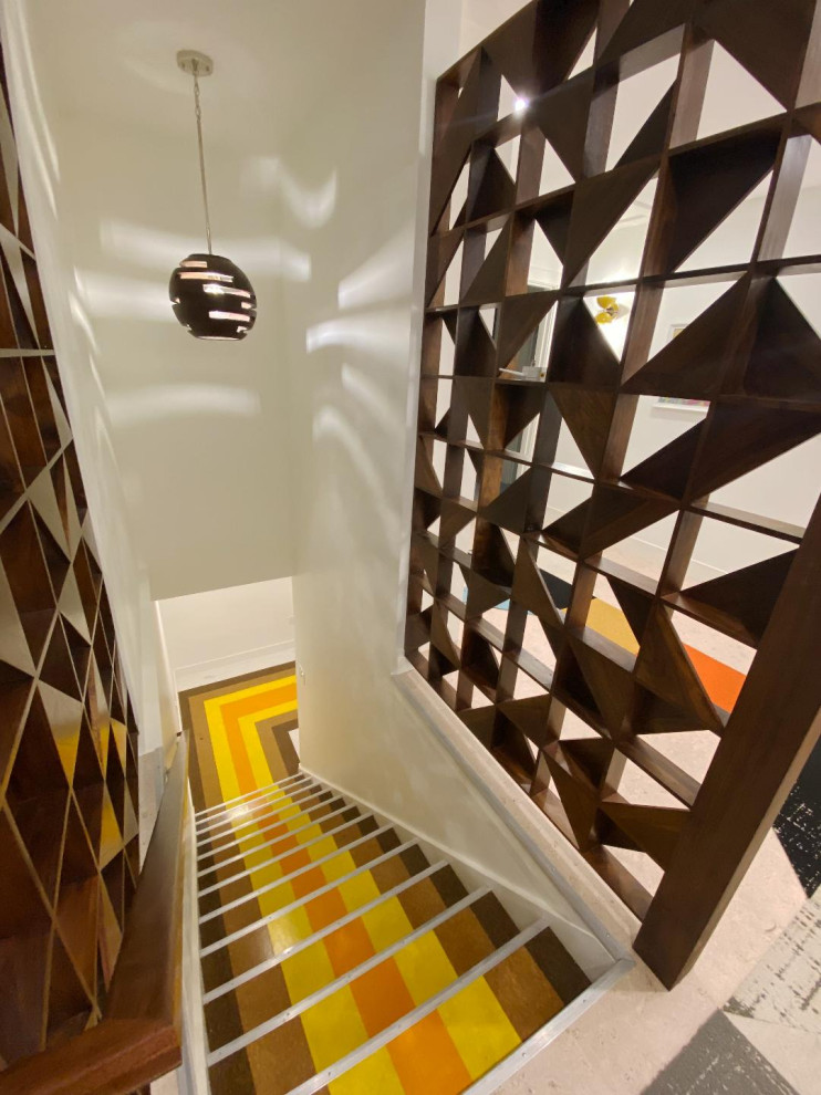 This is an example of a midcentury staircase in Denver with wood railing.