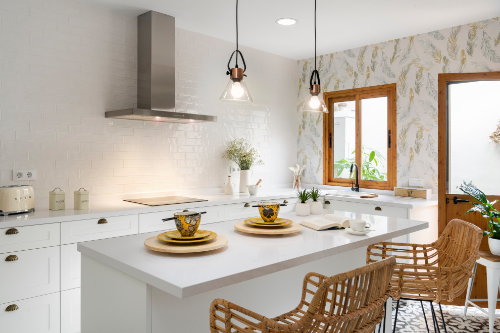 Design ideas for a contemporary l-shaped kitchen in Seville with a drop-in sink, shaker cabinets, white cabinets, white splashback, terra-cotta splashback, with island, multi-coloured floor and white benchtop.