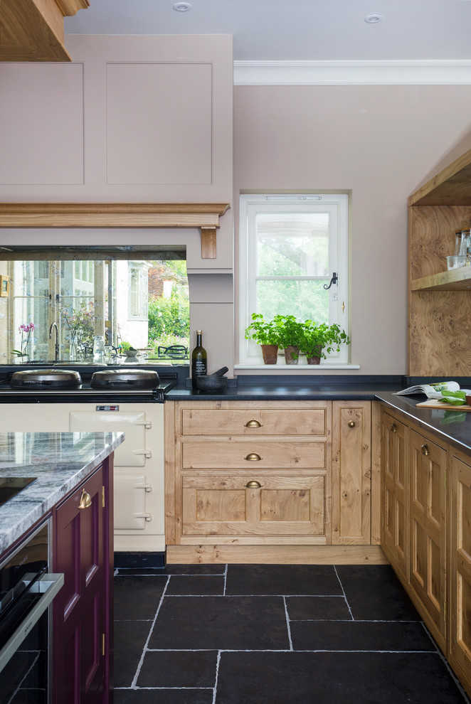 Photo of a transitional l-shaped kitchen in Hampshire with medium wood cabinets, coloured appliances and with island.