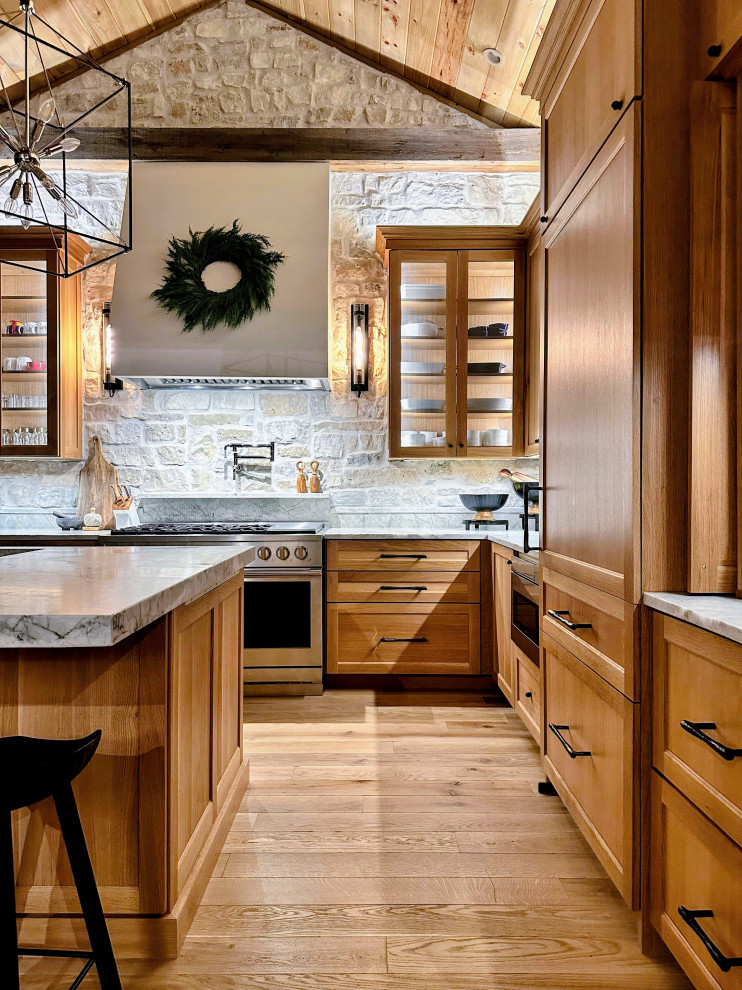 Inspiration for a transitional light wood floor and vaulted ceiling kitchen remodel with medium tone wood cabinets, quartzite countertops and an island