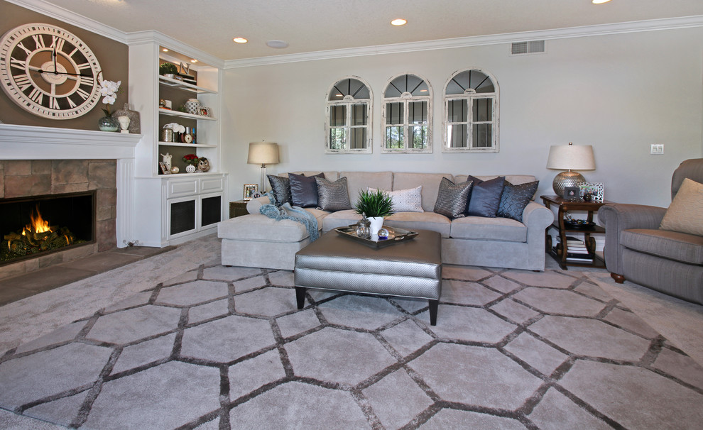 Inspiration for a mid-sized traditional enclosed living room in Orange County with grey walls, carpet, a standard fireplace, a stone fireplace surround, a built-in media wall and grey floor.