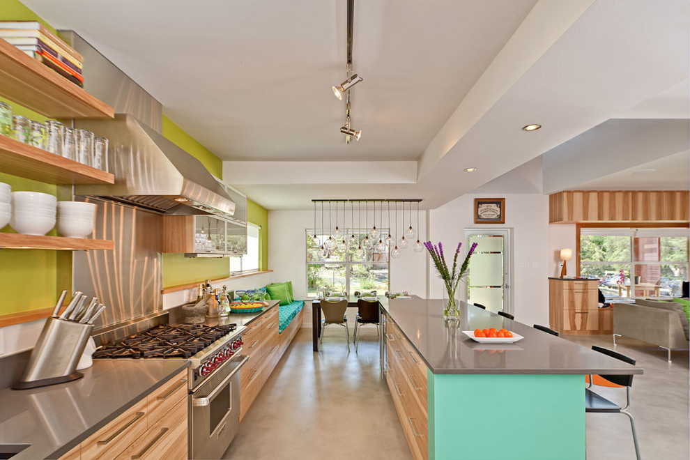 Contemporary open plan kitchen in Austin with stainless steel appliances, open cabinets, quartz benchtops and medium wood cabinets.