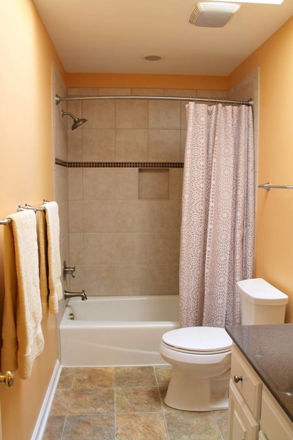 Vinyl Floor, Kohler Toilet in White, Tile Tube Surround ...