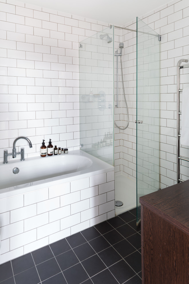 Design ideas for a mid-sized scandinavian master bathroom in London with dark wood cabinets, wood benchtops, a drop-in tub, a corner shower, white tile, subway tile, white walls and slate floors.