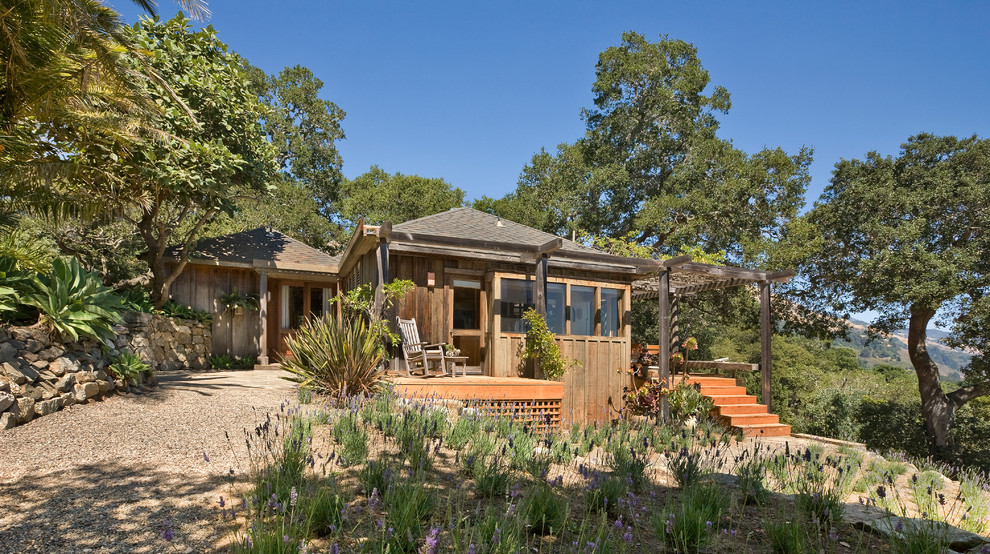 This is an example of a country exterior in San Francisco with wood siding and a hip roof.