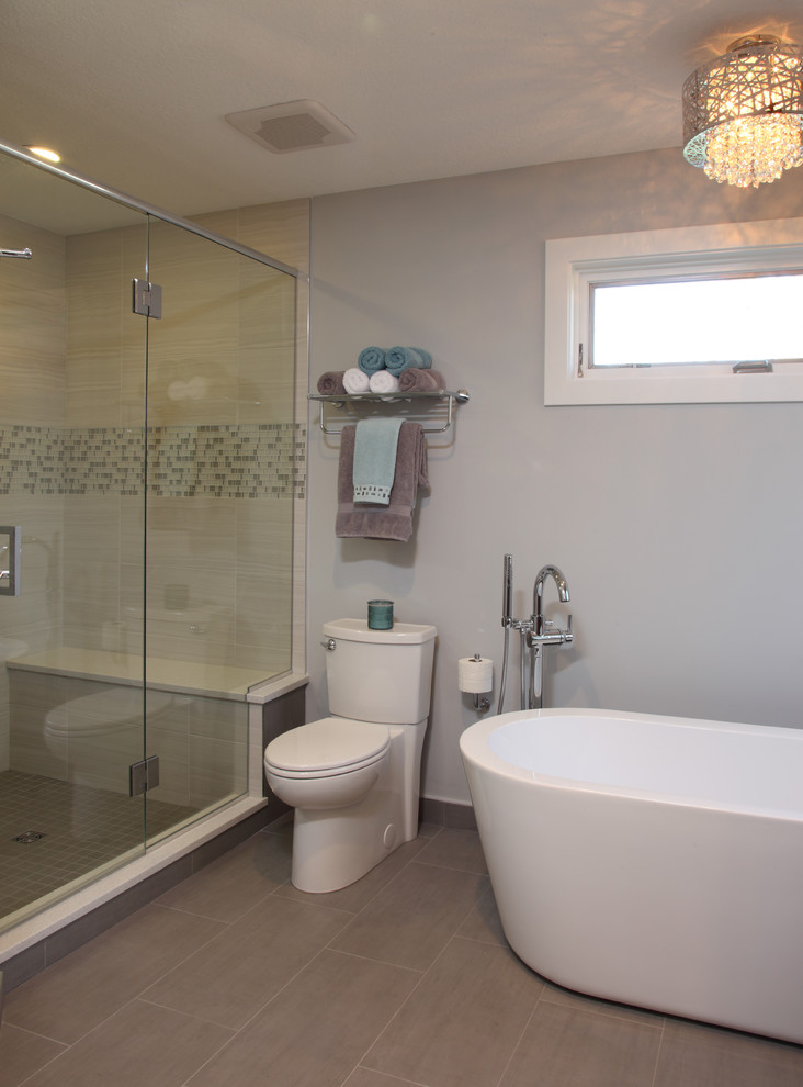 Mid-sized transitional master gray tile and porcelain tile porcelain tile freestanding bathtub photo in Minneapolis with a two-piece toilet and gray walls