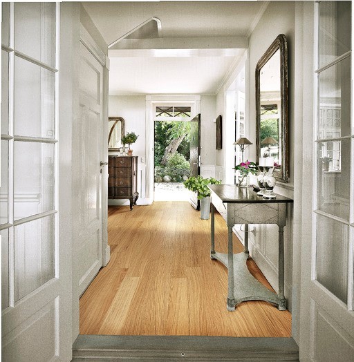 This is an example of a scandinavian hallway in London with white walls and medium hardwood floors.