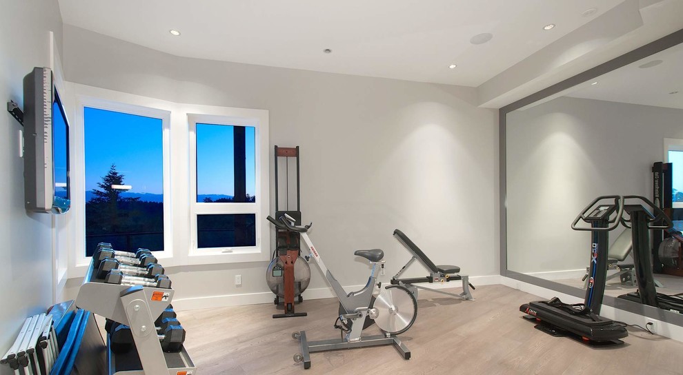 Inspiration for a mid-sized contemporary home weight room in New York with brown walls and porcelain floors.