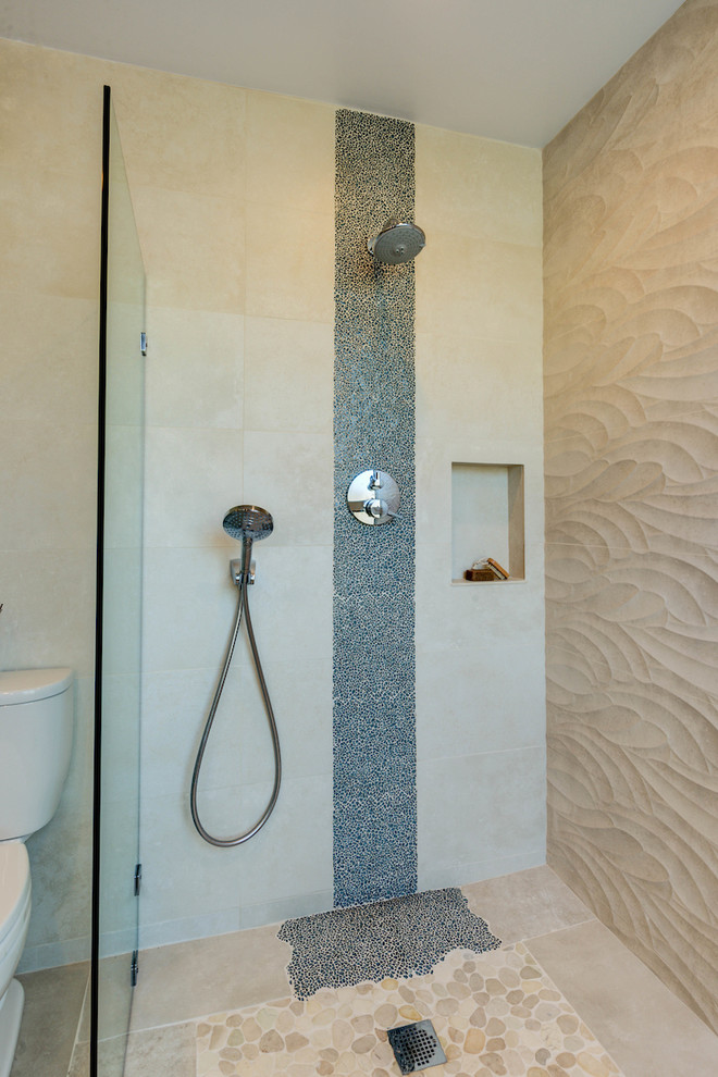 This is an example of a mid-sized beach style master bathroom in San Francisco with flat-panel cabinets, distressed cabinets, a curbless shower, a one-piece toilet, beige tile, porcelain tile, beige walls, porcelain floors, a trough sink and tile benchtops.