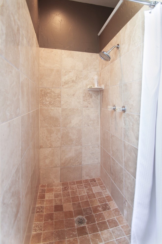 Example of a large minimalist master beige tile and ceramic tile travertine floor bathroom design in Dallas with an undermount sink, shaker cabinets, dark wood cabinets, limestone countertops, a one-piece toilet and multicolored walls