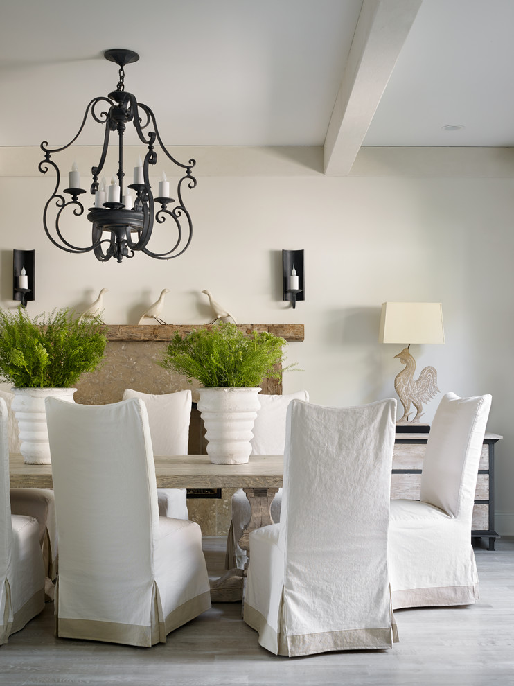 This is an example of a transitional dining room in Atlanta with white walls and light hardwood floors.