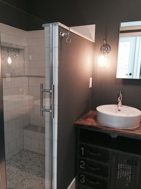 Photo of a mid-sized country 3/4 bathroom in Baltimore with shaker cabinets, dark wood cabinets, a corner shower, brown walls, medium hardwood floors, a vessel sink and wood benchtops.