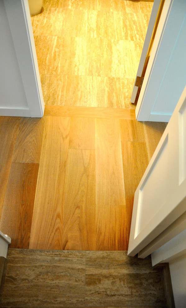 This is an example of a mid-sized contemporary hallway in Vancouver with white walls, light hardwood floors and beige floor.