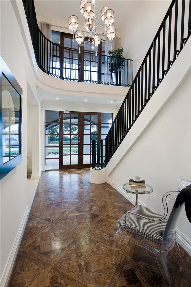 Photo of a large traditional foyer in Melbourne with white walls, medium hardwood floors, a double front door and a glass front door.