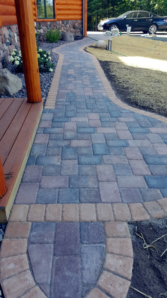 Inspiration for a rustic partial sun front yard concrete paver driveway for summer.