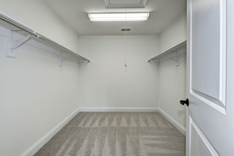 Walk-in closet - large transitional gender-neutral carpeted walk-in closet idea in DC Metro