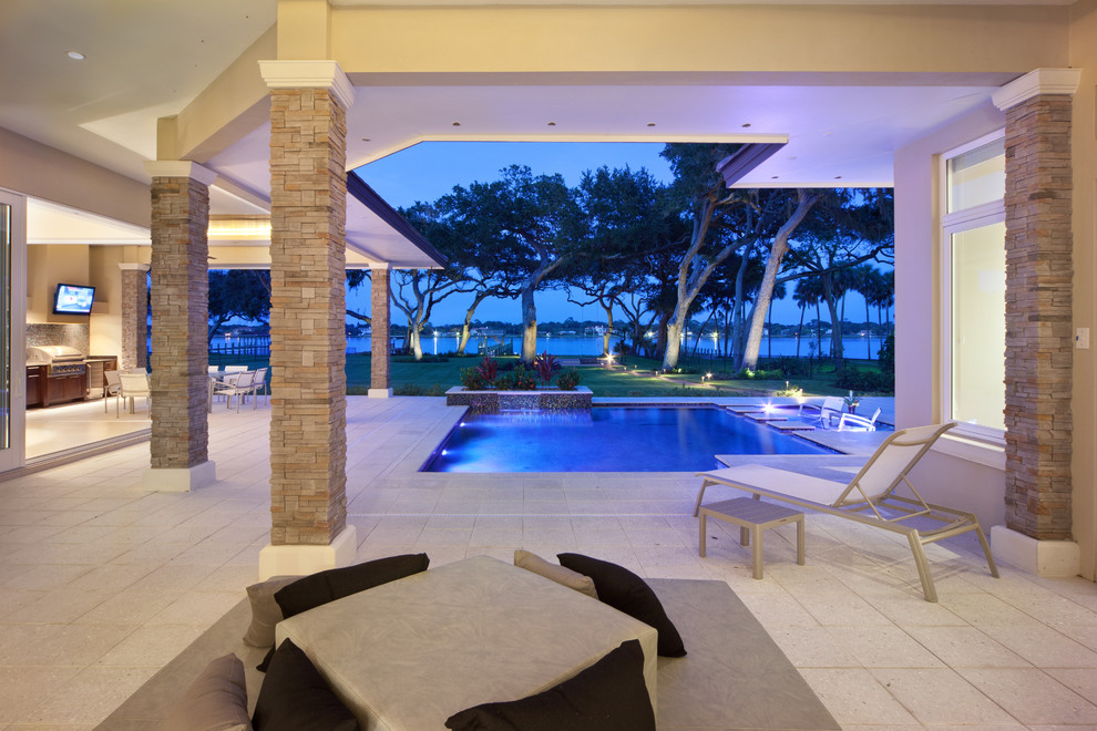 Design ideas for a contemporary courtyard custom-shaped pool in Orlando with tile.