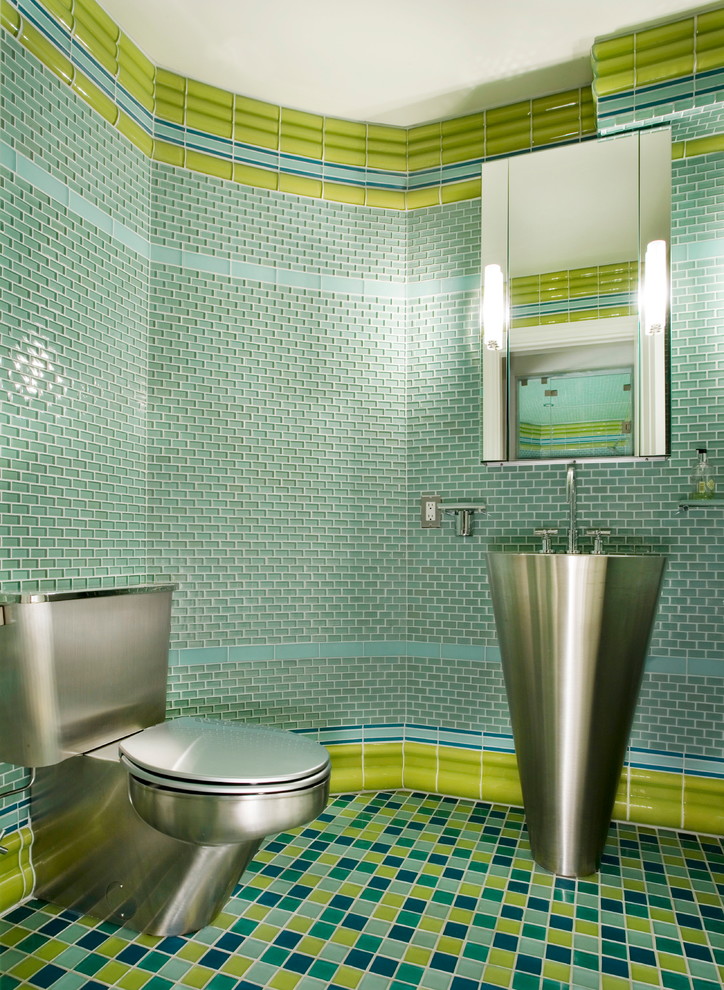 This is an example of a small modern powder room in Boston with stainless steel benchtops, green tile, blue tile, glass tile, a pedestal sink and green walls.