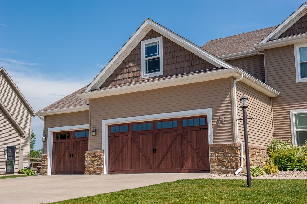 This is an example of a large transitional attached three-car garage in Cleveland.