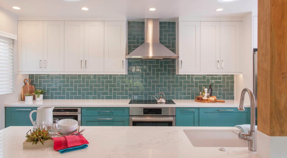 Inspiration for a mid-sized transitional kitchen in San Diego with an undermount sink, shaker cabinets, white cabinets, quartzite benchtops, green splashback, glass tile splashback, stainless steel appliances and white benchtop.
