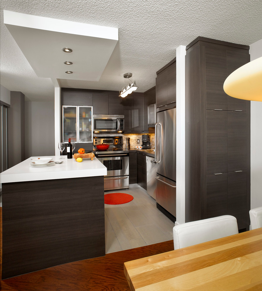 Mid-sized modern l-shaped kitchen pantry in Montreal with a drop-in sink, flat-panel cabinets, dark wood cabinets, quartzite benchtops, multi-coloured splashback, cement tile splashback, stainless steel appliances, ceramic floors and with island.