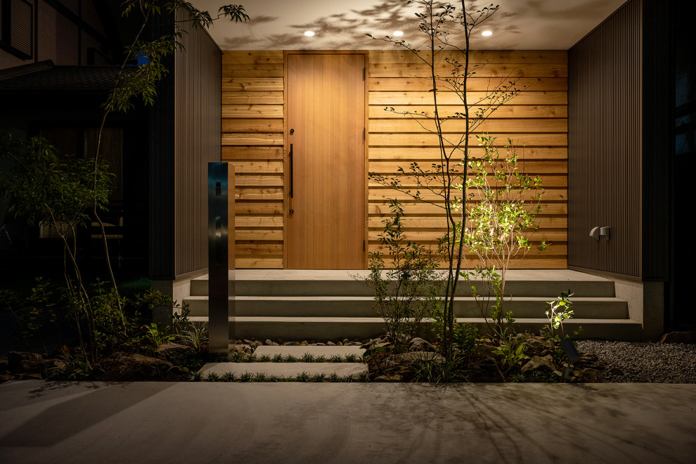 Idee per un piccolo portico nordico davanti casa con con illuminazione e pavimentazioni in cemento