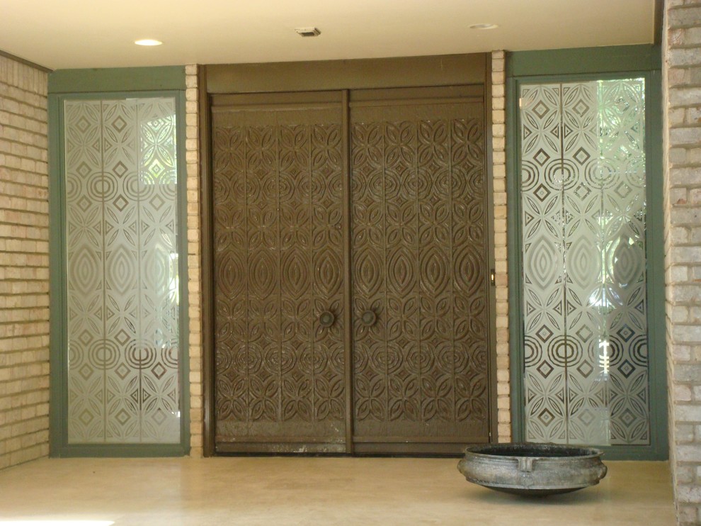 Photo of a large eclectic front door in Houston with green walls, travertine floors, a double front door and a brown front door.