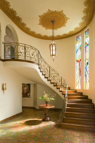 Design ideas for a traditional foyer in Los Angeles with white walls, terra-cotta floors, a double front door and a metal front door.