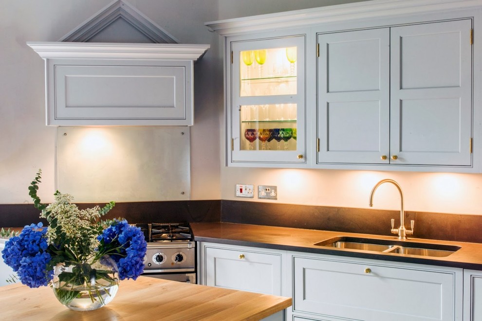 Inspiration for a large traditional u-shaped separate kitchen in Wiltshire with an undermount sink, blue cabinets and with island.