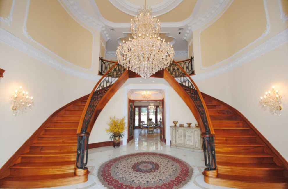 Design ideas for an expansive traditional wood curved staircase in New York with wood risers.