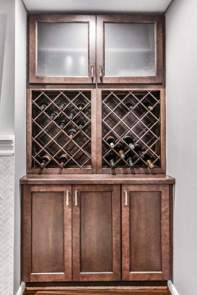 Inspiration for a Large transitional Walk-out basement in DC Metro With a Home Bar, Grey Walls, Laminate Floors, a Ribbon Fireplace and a Tile Fireplace Surround.