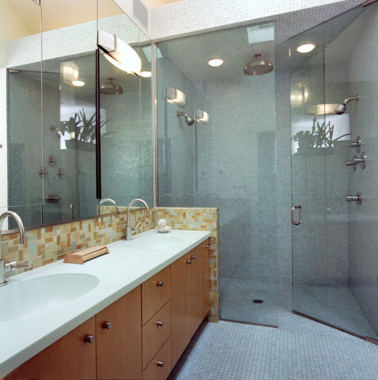 Photo of a mid-sized contemporary master bathroom in Chicago with flat-panel cabinets, medium wood cabinets, an alcove shower, beige tile, glass tile, beige walls, mosaic tile floors, an integrated sink, quartzite benchtops, blue floor, a hinged shower door, turquoise benchtops, a double vanity, a built-in vanity and vaulted.
