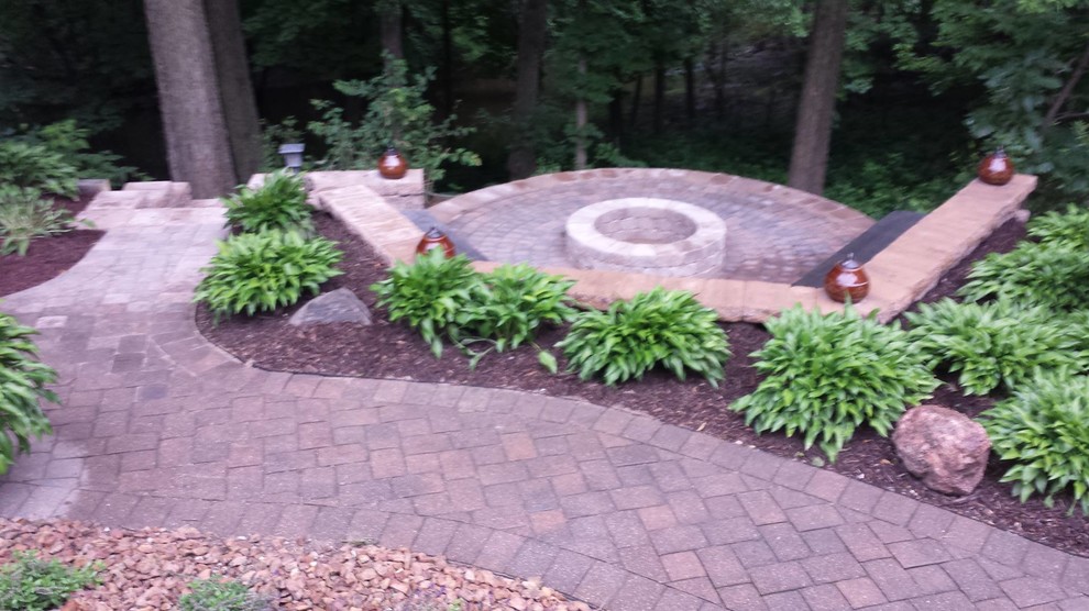 Photo of a backyard patio in Minneapolis with a fire feature and brick pavers.