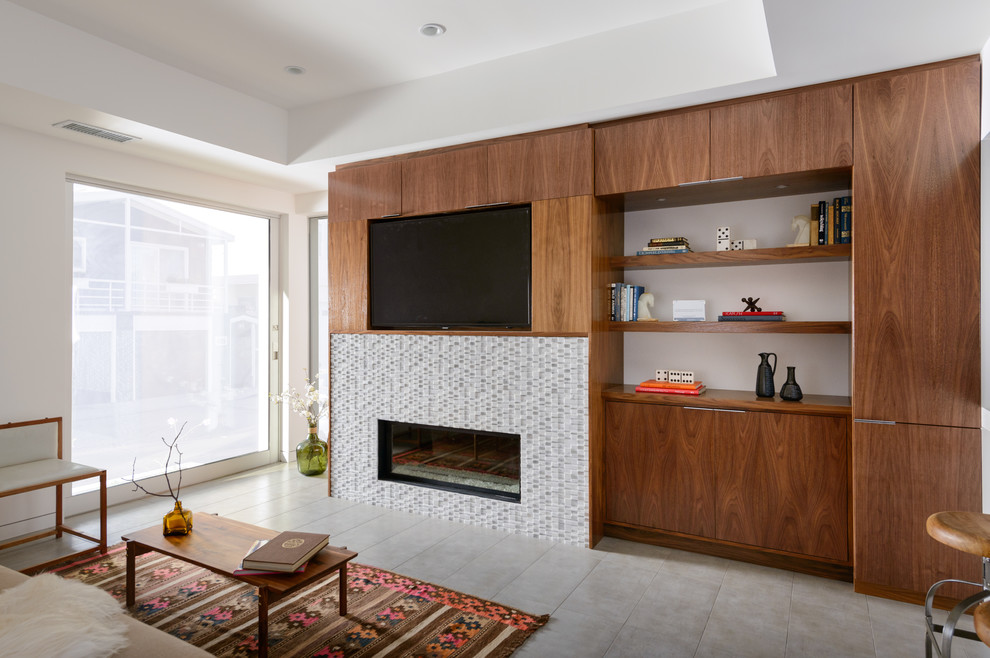 Photo of a contemporary living room in Los Angeles with a ribbon fireplace and a built-in media wall.