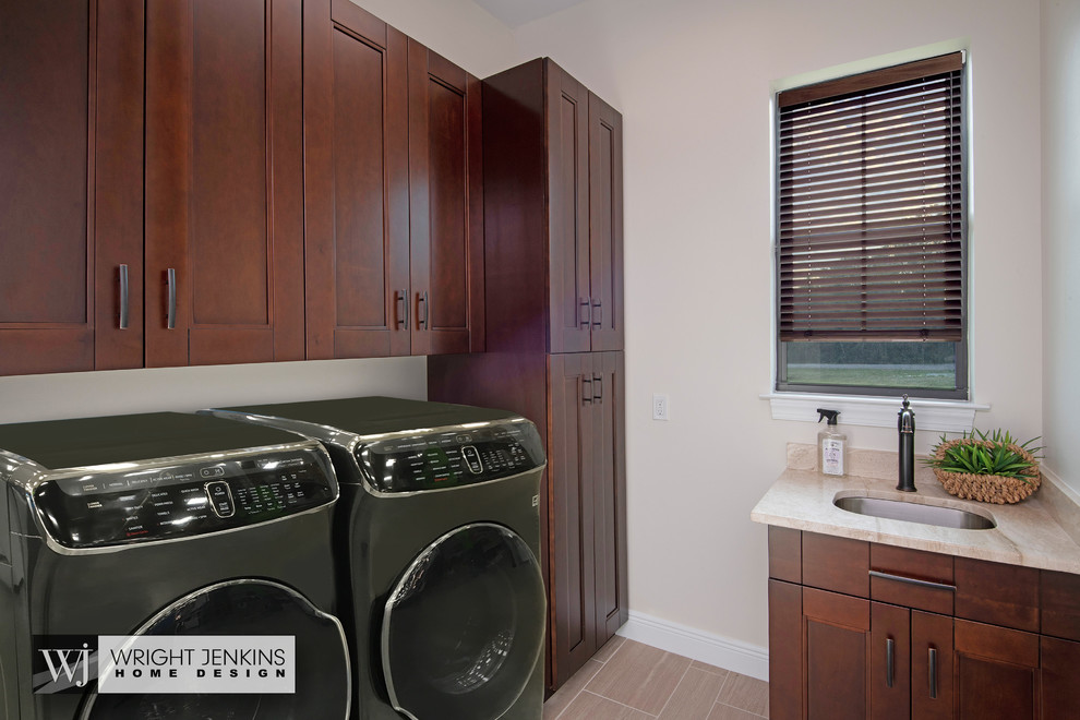 Inspiration for a small mediterranean galley dedicated laundry room in Other with an undermount sink, flat-panel cabinets, medium wood cabinets, granite benchtops, beige walls, porcelain floors, a side-by-side washer and dryer, beige floor and beige benchtop.