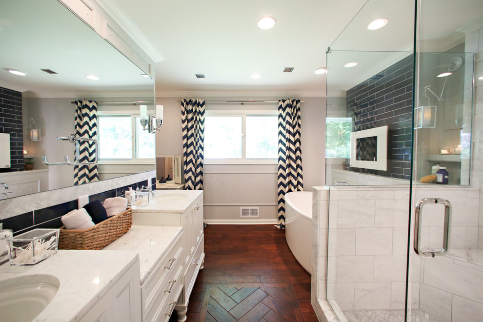 Large transitional master bathroom in Minneapolis with recessed-panel cabinets, white cabinets, a freestanding tub, an open shower, blue tile, ceramic tile, grey walls, dark hardwood floors, marble benchtops, a one-piece toilet, an undermount sink, red floor and a hinged shower door.