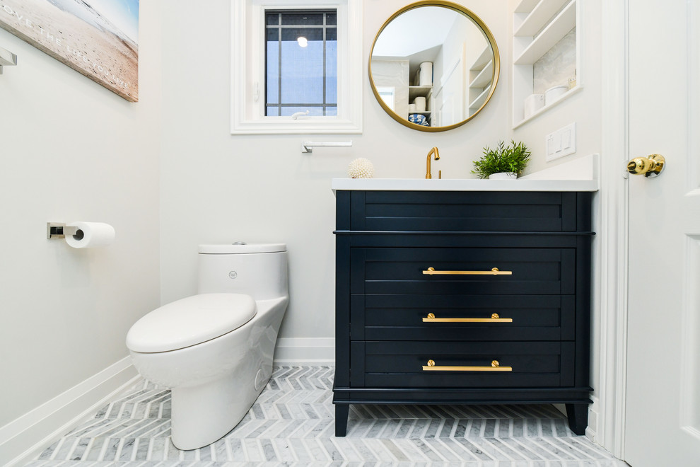 Example of a small transitional master multicolored tile and porcelain tile mosaic tile floor and multicolored floor drop-in bathtub design in Toronto with furniture-like cabinets, blue cabinets, a one-piece toilet, white walls, a drop-in sink, quartz countertops, a hinged shower door and white countertops