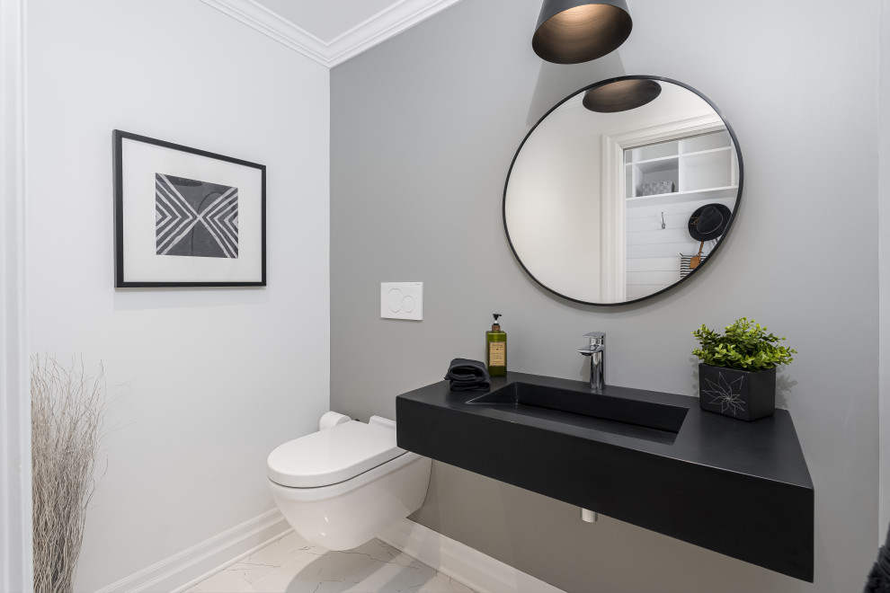 Photo of a small contemporary powder room in Montreal with a wall-mount toilet, grey walls, porcelain floors, an integrated sink, engineered quartz benchtops, yellow floor, black benchtops and a floating vanity.