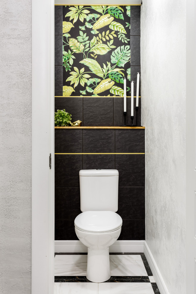 This is an example of a small contemporary powder room in Other with a two-piece toilet, black tile and white walls.