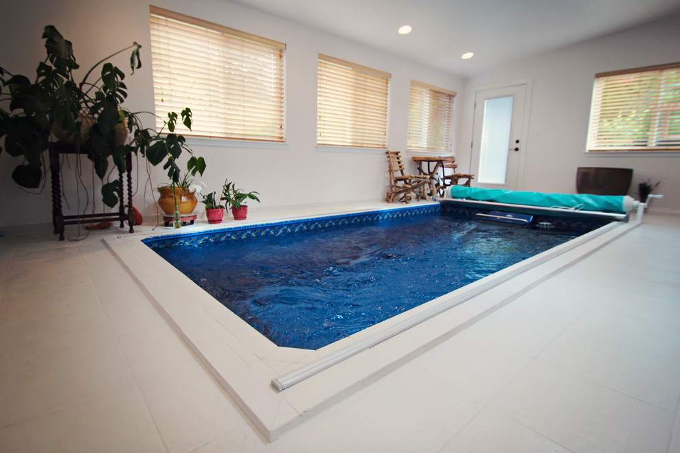 Photo of a small traditional indoor rectangular lap pool in Seattle with tile and a hot tub.