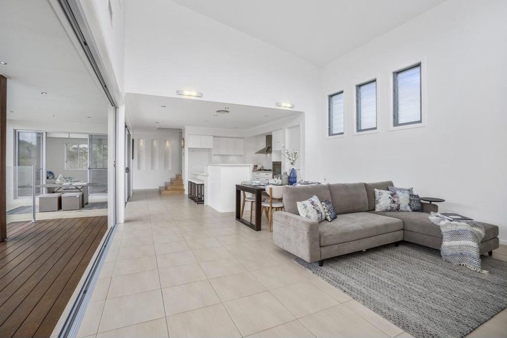 Mid-sized beach style open concept living room in Gold Coast - Tweed with white walls.