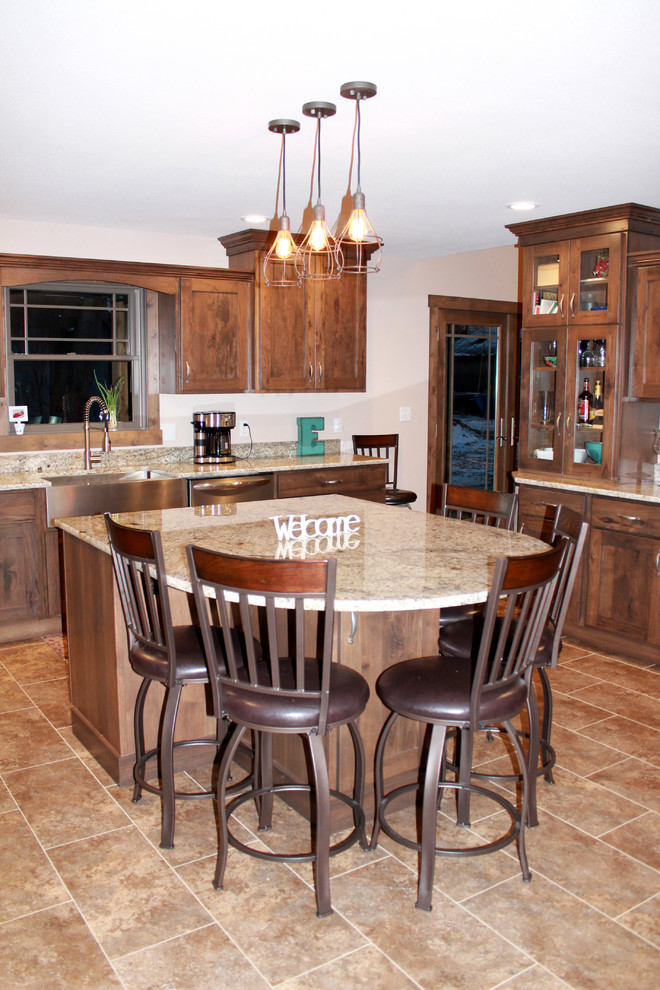 Example of a large mountain style l-shaped eat-in kitchen design in Chicago with a farmhouse sink, shaker cabinets, dark wood cabinets, granite countertops, stainless steel appliances and an island