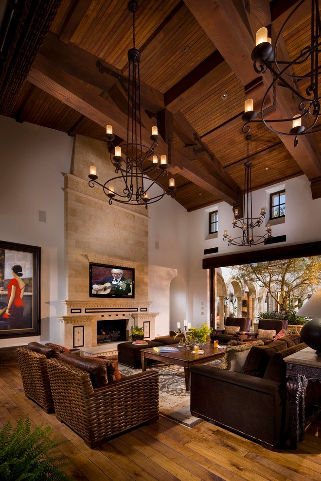 This is an example of a mediterranean living room in Orange County with a tile fireplace surround.